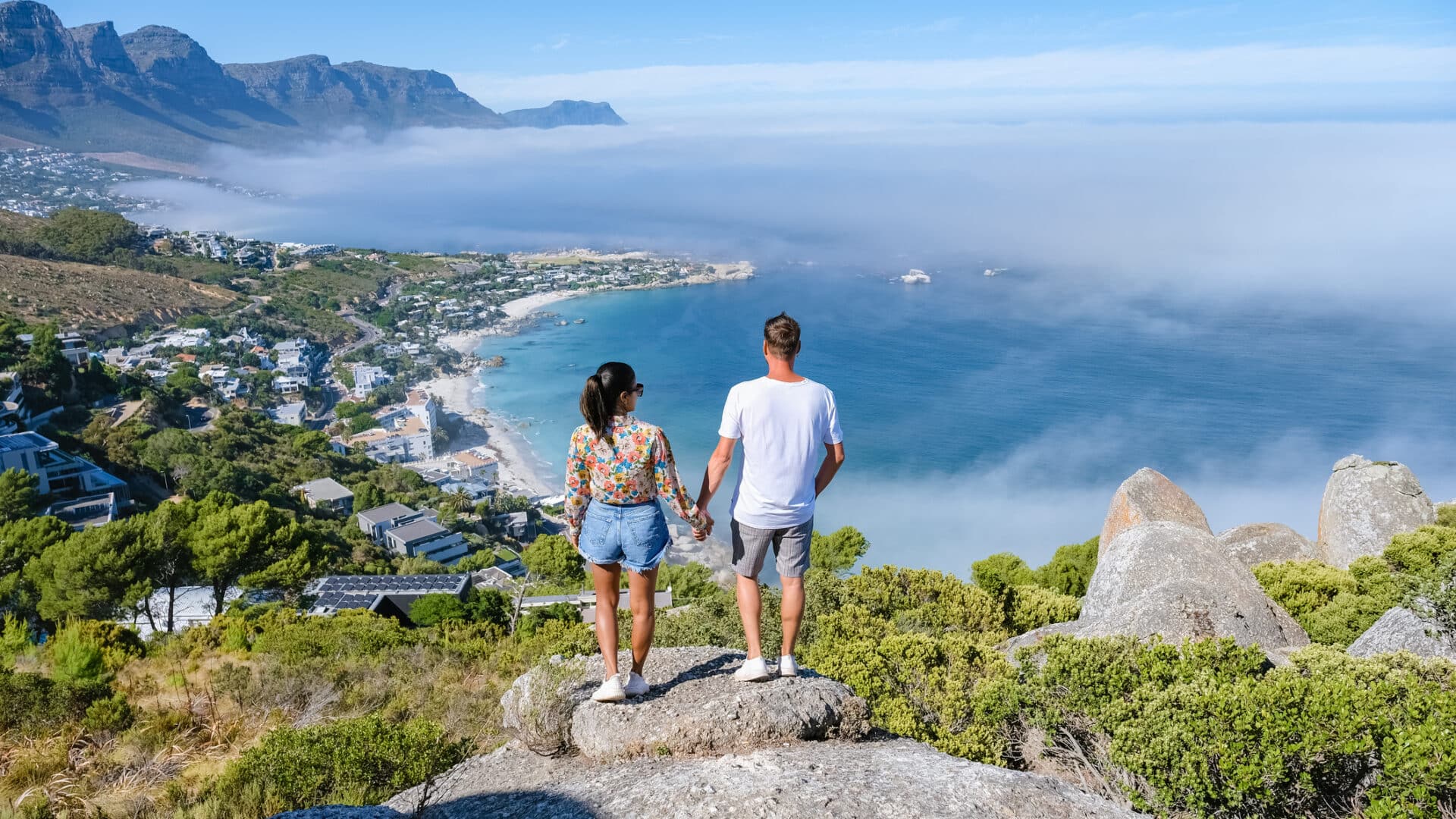 View from The Rock viewpoint in Cape Town over Campsbay, view over Camps Bay with fog over the ocean. fog coming in from ocean at Camps Bay Cape Town